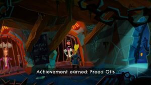 a dank, dimly lit jail call. a man in a white shirt with a dark beard stands behind jail cells bars while Guybrush peers at the lock on the cell door. Wood beams stretch from the walls to the ceiling. another man in a large hat stands in the next cell over