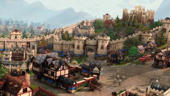 Uma cena do Age of Empires, mostrando um assentamento de castelo, com várias ameias e prédios antigos, caminhos pontilhados de folhagem e pequenas figuras andando por aí.