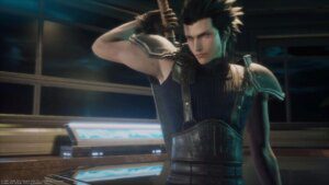 Zack Fair, a young man in a dark, tight-fitting tank top with armor shoulder guards, stands in a building lobby. He