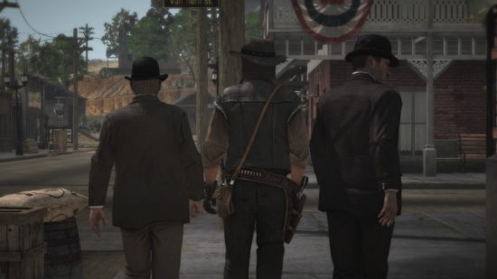 Leia a captura de tela da análise do Dead Redemption Switch mostrando as costas de três homens enquanto eles entram em uma cidade.  Os dois dos lados estão de terno e chapéu elegante, no meio está um cowboy.