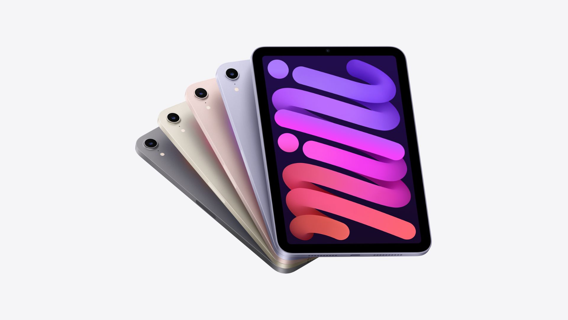 melhor-ipad-5 Um dos melhores iPads, o iPad mini, mostrado várias vezes, espalhado como um baralho de cartas em várias cores (da esquerda para a direita – preto, verde, rosa, roxo, roxo).  O mais à esquerda está no topo da pilha e voltado para cima, com traços coloridos roxos e vermelhos em sua tela, o restante está escondido uns pelos outros como cartas, mostrando apenas um pequeno anel de câmera em cada canto superior esquerdo.